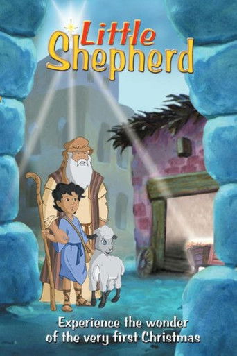 The poster features a young shepherd boy and a small white sheep, set against a mystical, snowy landscape. Warm golden tones contrast with cool blue hues, evoking a magical, serene atmosphere. The title "Little Shepherd" is prominently displayed at the top, while the tagline suggests an enchantin...