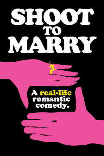 The poster features bold white text against a stark black background, with two pink hands clasped together at the bottom. A small yellow heart floats above the palms, suggesting romance and affection. The overall design conveys a playful, intimate romantic comedy vibe.