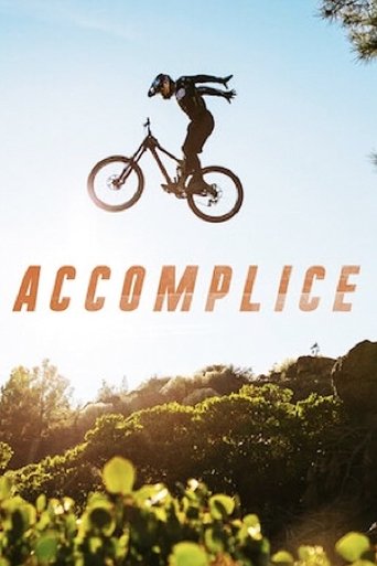 A lone BMX rider in mid-air against a bright sky, surrounded by lush greenery. The word "ACCOMPLICE" in bold, warm tones anchors the image, evoking a sense of adventure and camaraderie.