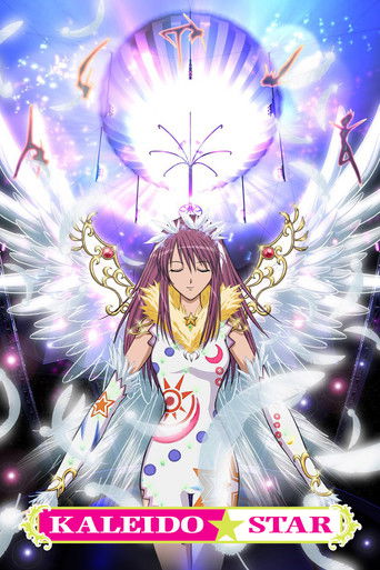 A radiant anime character with angelic wings and a crown stands before a glowing orb, surrounded by magical energy and floating crystals. The vibrant purple and blue hues create a mystical atmosphere, while the title "Kaleido Star" in bold pink text anchors the composition.