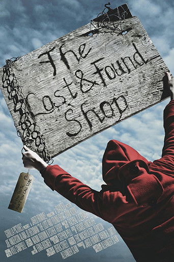A hooded figure in red holds up a weathered wooden sign that reads "The Lost & Found Shop," evoking a gritty, noir atmosphere against a cloudy sky.