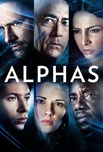 The poster features seven intense characters with dramatic expressions, set against a dark blue background with glowing blue lines. The title "ALPHAS" is prominently displayed in bold white letters, conveying a sense of mystery and intrigue.