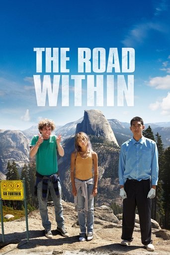 The poster features three individuals standing on a rocky cliff overlooking a breathtaking mountain landscape under a bright blue sky. The vibrant colors of the clothing and natural scenery evoke a sense of adventure and freedom. The title "The Road Within" is prominently displayed in bold white ...