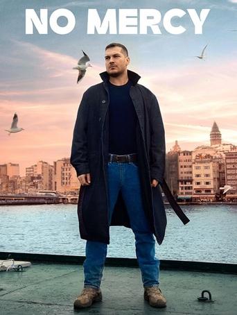 The poster features a man standing on a dock, wearing a long coat and jeans, with a dark umbrella in his hand. The background showcases a cityscape at sunset, with birds flying overhead and a calm body of water reflecting the sky's hues. The title "NO MERCY" is prominently displayed at the top in...
