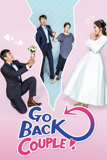 The poster features four characters in a romantic setting, with a man kneeling while another stands behind him. A woman in a white dress and a man in a blue suit are positioned on the right. The background is a soft pink with a blue heart shape, creating a dreamy atmosphere. The title "Go Back Co...