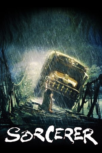 The poster depicts a dark, stormy night with a mysterious figure standing on a crumbling bridge. The scene is filled with ominous colors—deep blues, greens, and blacks. The title "Sorcerer" is prominently displayed at the bottom in a gothic font, adding to the eerie atmosphere.
