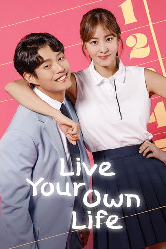 The poster features two smiling individuals in a cheerful, vibrant setting with warm pink and yellow tones. The man in a light blue suit stands on the left, while the woman in a white blouse and dark skirt stands on the right, both exuding confidence and happiness. The title "Live Your Own Life" ...
