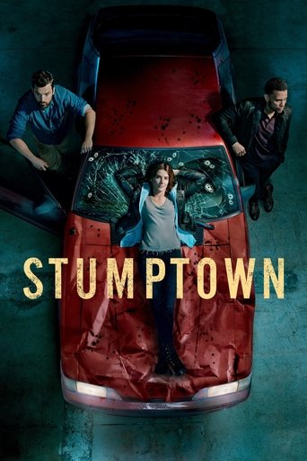 The poster features a red pickup truck with a young man standing on its hood, surrounded by two men leaning on the sides. The scene is set in a dimly lit environment with a moody, atmospheric tone. The title "STUMPTOWN" is prominently displayed in bold, golden letters across the lower part of the...
