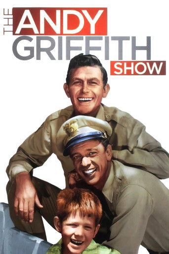 The Andy Griffith Show poster features Andy Griffith, a cheerful sailor, alongside a young boy in the foreground. The warm tones of olive green and red create a nostalgic, inviting atmosphere, capturing the essence of classic rural life.