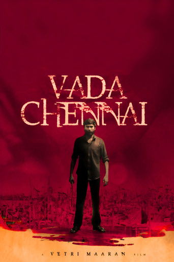 The poster features a man standing against a dramatic red backdrop, evoking a sense of mystery and tension. The title "Vada Chennai" is prominently displayed in bold, distressed typography, suggesting a gritty or intense narrative. The overall composition conveys a somber and suspenseful mood, hi...