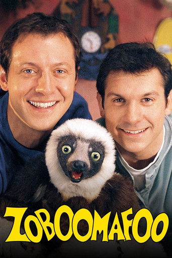 Two smiling men hold a small, expressive lemur in a warm, inviting setting. The vibrant yellow title text adds a playful touch, while the soft lighting and cheerful expressions create a friendly, nostalgic atmosphere.