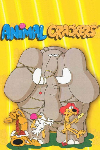 The poster features a cheerful yellow background with the title "Animal Crackers" in playful, colorful letters. An elephant stands prominently in the center, surrounded by four animated characters dressed in bright, cartoonish outfits. The mood is lighthearted and fun, capturing the essence of a ...
