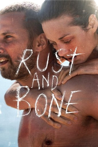 The poster features a shirtless man and woman embracing tightly, their skin glistening in the sunlight. The title "Rust and Bone" is written in bold, white, distressed lettering across their faces. The mood is intense and raw, evoking themes of survival and resilience.