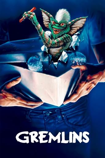 The poster features a menacing green Gremlin with wings and a sinister grin, looming over a figure in a blue suit who holds a glowing blue orb. The dark blue background enhances the eerie atmosphere, while the bold white title "GREMLINS" anchors the composition.