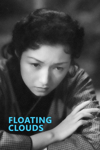 A black-and-white portrait captures a woman with a contemplative expression, her dark hair styled in waves. The muted tones of the photograph convey a somber mood, while the blue text "FLOATING CLOUDS" adds a subtle, dreamlike quality to the image.