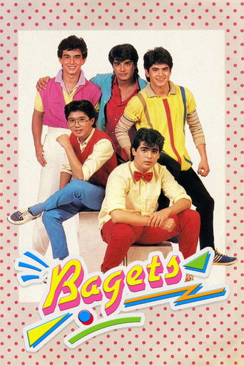 The poster features six young men in colorful, retro-style clothing against a pink polka-dot background. The mood is playful and youthful, with bright yellows, reds, and blues creating a vibrant, energetic atmosphere. The title "Bagets" is prominently displayed in bold, colorful letters at the bo...