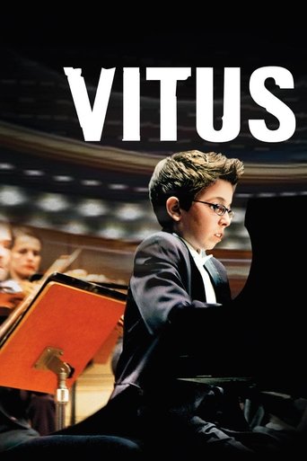 The poster features a young boy in a dark suit playing the piano, with a warm, intimate atmosphere. The title "VITUS" is prominently displayed in bold white letters against a dark background.