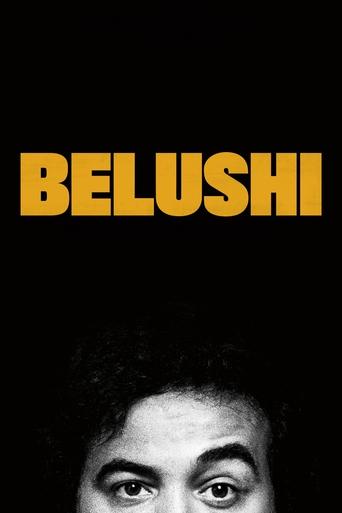 The poster features a close-up of a person's face with intense, piercing eyes against a stark black background. The bold, yellow text "BELUSHI" dominates the top, creating a striking contrast that suggests mystery and intrigue.