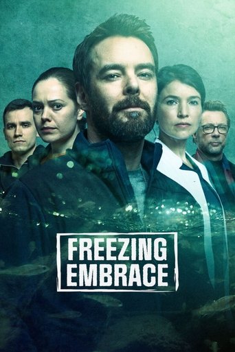 The poster features a group of characters in a somber, misty atmosphere with muted blues and greens. The central figure, a bearded man, dominates the frame with a serious expression, while others look concerned or contemplative. The title "Freezing Embrace" is prominently displayed in bold white ...