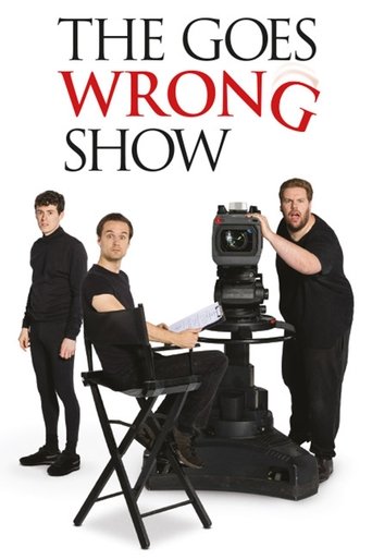 The poster features four men in formal attire against a stark white background. The title "THE GOES WRONG SHOW" is prominently displayed in bold red and black text. The mood is humorous and dramatic, suggesting a comedy sketch show with a serious tone.