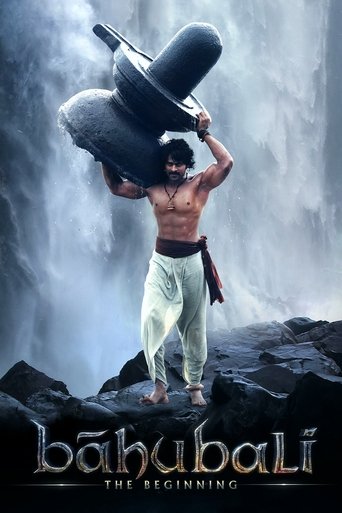 The poster features a muscular man in white pants carrying a large black sack over his shoulder, standing on rocky terrain near a waterfall. The dark, moody atmosphere contrasts with the bright, almost neon colors of the title and text. The mood is mysterious and adventurous, hinting at a thrilli...