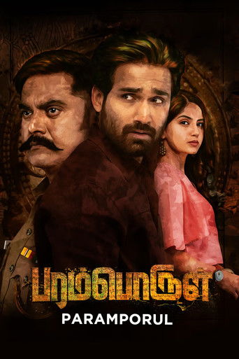 The poster features three characters in a dramatic pose against a dark, moody background. The warm tones of the characters' clothing contrast with the cool, shadowy backdrop, creating an intense atmosphere. The title "Paramporul" is prominently displayed in bold, golden letters, suggesting a powe...