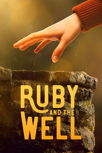 The poster features a warm, golden hand reaching toward a weathered stone well, evoking mystery and wonder. The text "Ruby and the Well" is prominently displayed in bold, yellow letters, suggesting a story about hidden treasures or supernatural elements. The overall mood is enchanting and invitin...