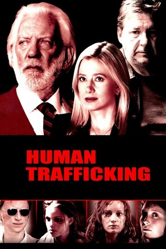 The poster features a dramatic, somber scene with a man in a suit and a woman in a red dress, both looking serious and intense. The title "Human Trafficking" is prominently displayed in bold red letters against a black background. The overall mood is one of suspense and gravity, emphasizing the s...