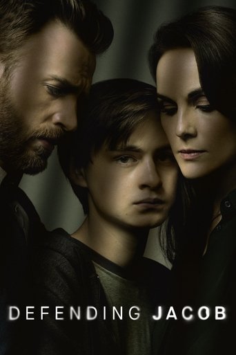 The poster features three characters in a dark, moody setting with muted tones. The central figure looks determined, while the others lean in close, creating an intense and dramatic atmosphere. The title "Defending Jacob" is prominently displayed at the bottom, emphasizing the show's serious tone.