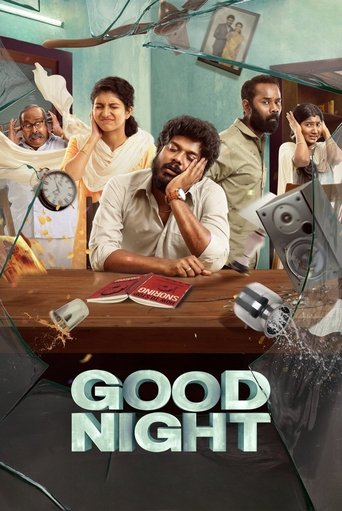The poster features a group of people gathered around a wooden table, with one man in the foreground holding a phone to his ear. The scene is set in a dimly lit room with a clock on the wall and various objects scattered around, creating a mysterious and slightly eerie atmosphere. The title "GOOD...