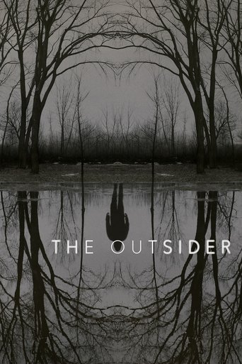 The poster features a haunting, monochromatic landscape with bare trees reflecting in a still body of water. The title "THE OUTSIDER" is centered in stark white text, evoking isolation and mystery. The overall mood is eerie and atmospheric, suggesting themes of loneliness and the unknown.