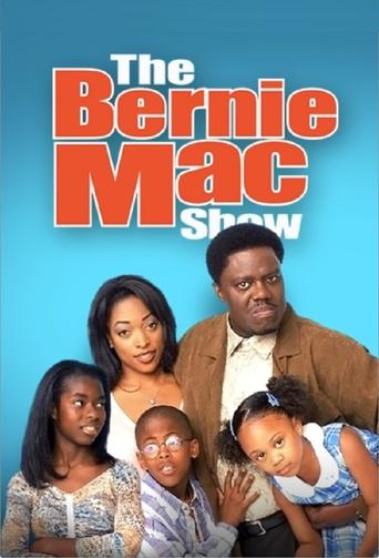 The poster features a family of four—Bernie Mac, his wife, and two daughters—standing against a vibrant blue background. The warm tones of their clothing contrast with the cool blue backdrop, creating a balanced and inviting atmosphere. The image conveys a sense of warmth and familial connection,...