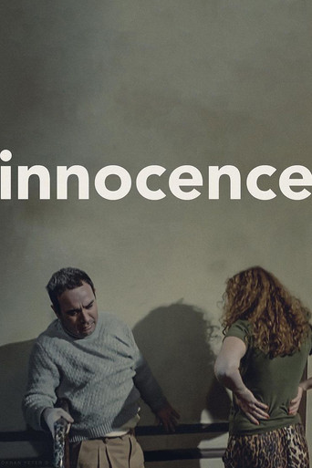 The poster features a somber scene with a man in a gray sweater and a woman in a green dress, both standing against a muted, gray background. The mood is melancholic, evoking themes of regret and introspection. The title "Innocence" is prominently displayed in white text, suggesting a poignant ex...