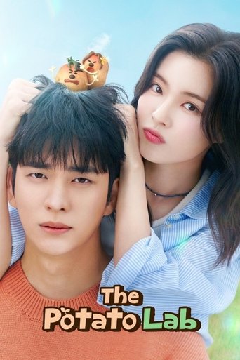 The poster features a young man and woman in a tender, intimate pose against a soft blue sky. The man wears a warm orange shirt, while the woman dons a light blue blouse. Their expressions convey a mix of curiosity and affection, suggesting a playful yet heartfelt narrative. The title "The Potato...