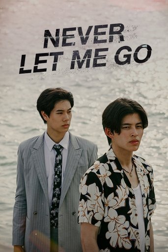 The poster features two young men standing against a beach backdrop. The man on the left wears a gray suit and tie, while the man on the right sports a black-and-white floral shirt. The text "NEVER LET ME GO" is prominently displayed at the top in bold, white letters. The overall mood is somber a...