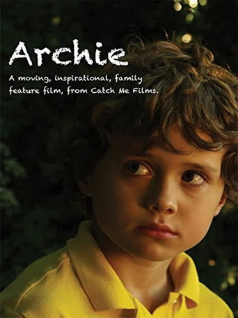 The poster features a young boy with curly brown hair, wearing a bright yellow shirt against a dark, moody background. His expression is serious and contemplative, suggesting themes of introspection and emotional depth. The warm lighting highlights his face, creating a poignant and evocative atmo...