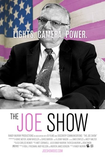 The Joe Show poster features a man in a suit against a patriotic American flag backdrop, exuding authority and confidence. The bold text "LIGHTS CAMERA POWER" emphasizes the show's dynamic energy, while the clean, modern design conveys professionalism and intrigue.