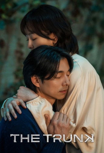 The Trunk poster captures a tender moment between two characters in a soft embrace, with warm lighting and muted tones evoking a sense of intimacy and emotional depth.