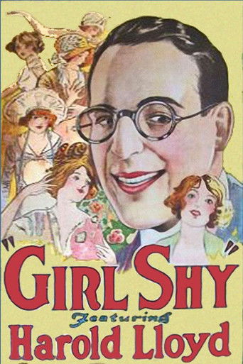 The poster features a large, smiling man with glasses in the center, surrounded by smaller illustrations of women in colorful dresses. The background is filled with warm yellow and pink hues, creating a cheerful and inviting atmosphere. The title "Girl Shy" is prominently displayed in bold red le...