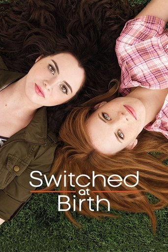The poster features two women lying on grass, one with dark hair and the other with red hair, both looking directly at the camera. The warm tones of their skin and the soft lighting evoke a sense of intimacy and connection. The title "Switched at Birth" is elegantly placed in the foreground, hint...