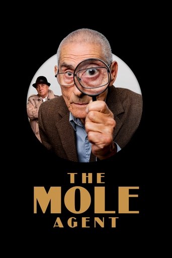 The poster features a close-up of an elderly man with a magnifying glass, pointing directly at the viewer against a stark black background. Behind him, a smaller figure in a uniform adds depth to the composition. The bold, golden text "THE MOLE AGENT" anchors the image, conveying a sense of myste...