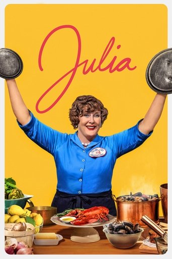 The poster features a cheerful woman with short brown hair in a bright blue chef's uniform, proudly holding up two large metal plates against a vibrant yellow background. She stands behind a table laden with colorful ingredients like lemons, tomatoes, and vegetables, suggesting a cooking show set...