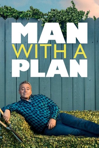 The poster features a man in a blue plaid shirt and jeans lying on a grassy field against a wooden fence. The title "MAN WITH A PLAN" is prominently displayed in bold white and yellow letters. The mood is casual and relaxed, suggesting a humorous or comedic tone.
