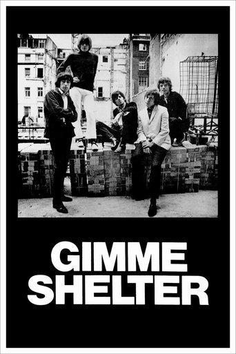 The poster features a gritty urban scene with five people standing on a brick wall, exuding a rebellious and defiant mood. The monochrome palette emphasizes the raw, unfiltered nature of the film's themes. The bold, white text "GIMME SHELTER" anchors the image, suggesting a bold, unconventional a...