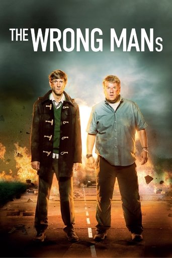 The poster features two men standing against a dramatic, fiery backdrop with smoky skies. The man on the left wears a dark jacket over a green shirt, while the man on the right dons a light blue shirt. The warm, intense lighting creates an ominous and mysterious atmosphere, hinting at the show's ...