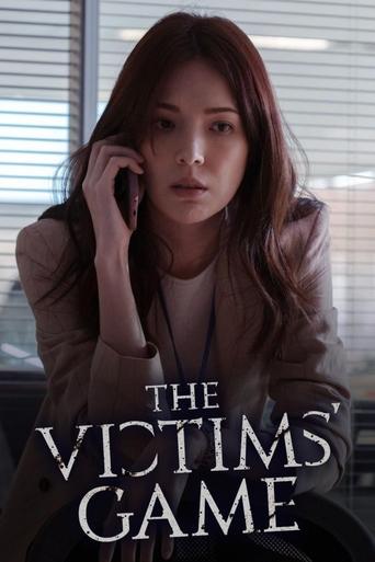 The poster features a woman with long brown hair holding a phone to her ear, her expression serious and contemplative. She wears a brown jacket over a white top, with a blurred office window in the background. The title "The Victims' Game" is prominently displayed in bold, white lettering. The ov...