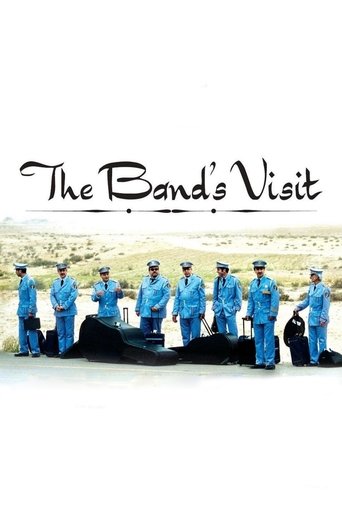 The poster features a group of uniformed band members in matching blue outfits standing solemnly beside a black coffin, evoking a somber and reflective mood. The title "The Band's Visit" is elegantly written in black script at the top, adding a touch of artistic flair to the image.