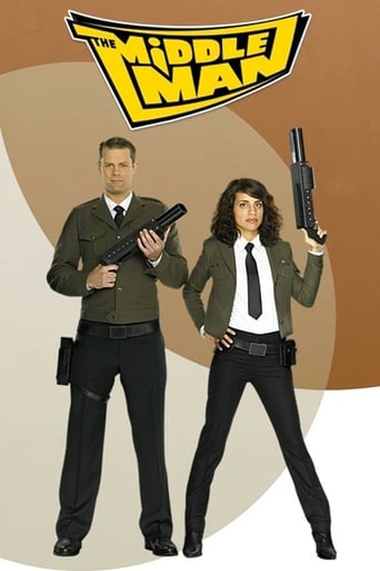 The Middleman poster features two characters in tactical gear against a warm, earthy background. The man on the left wears a green uniform and holds a rifle, while the woman on the right dons a black outfit with a gun, exuding confidence. The bold yellow logo at the top sets a gritty tone, sugges...
