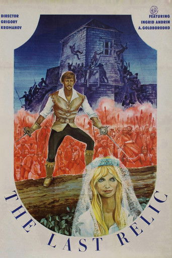 The poster features a dramatic scene with a man in a white shirt and black pants standing amidst fiery red flames, while a woman in a white dress and veil sits peacefully below. The background showcases a haunted house under a dark blue sky, creating a spooky yet mysterious atmosphere. The title ...