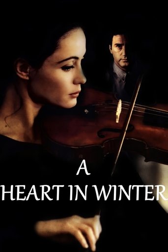 The poster features a woman playing a violin in a dimly lit scene, with a man in the background. The warm tones of the violin and the soft lighting create an intimate and emotional atmosphere. The title "A Heart in Winter" suggests a story about love and resilience during challenging times.